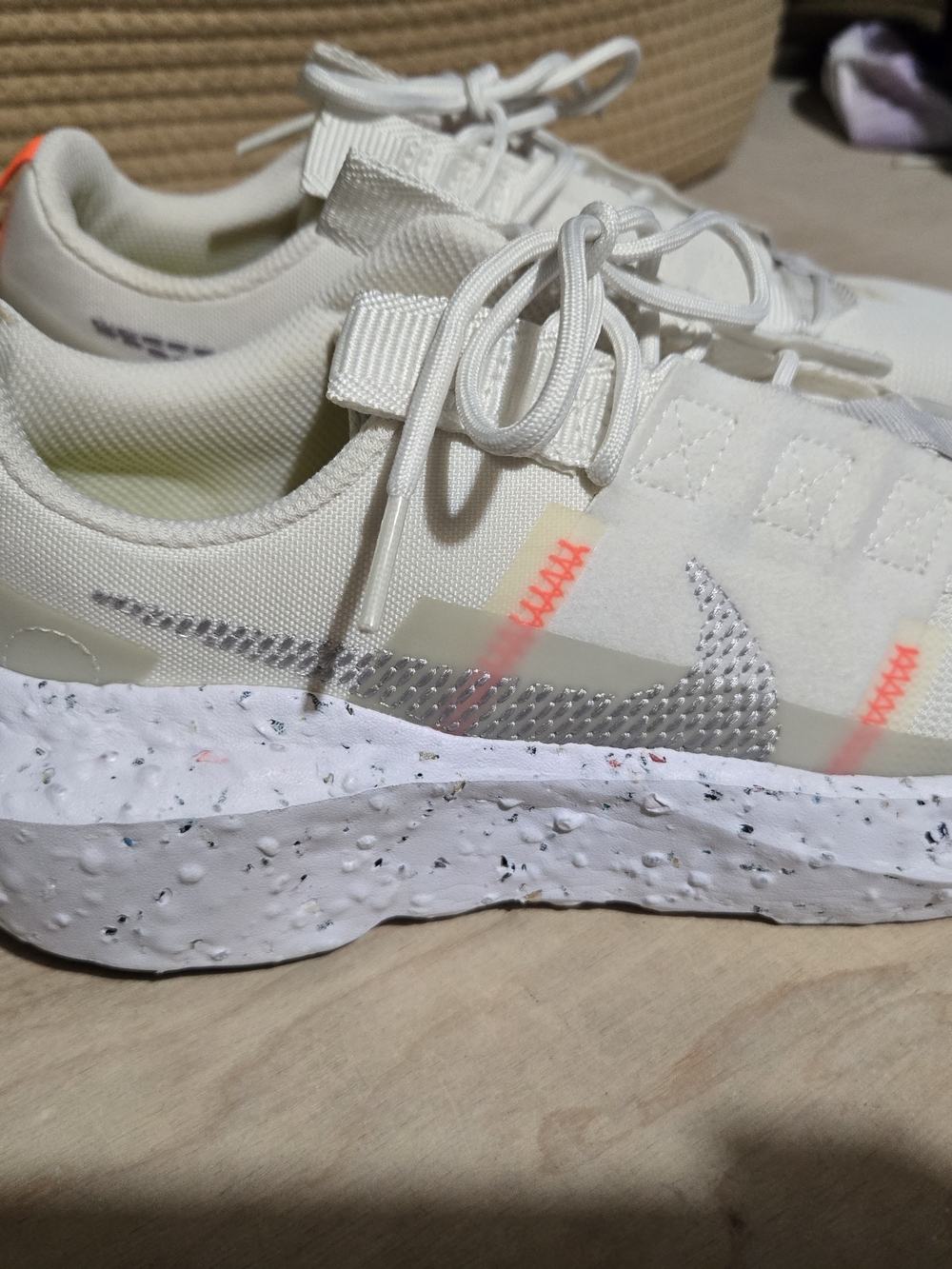 Nike Cream Sneakers with Neon Orange Accents and Speckled Sole